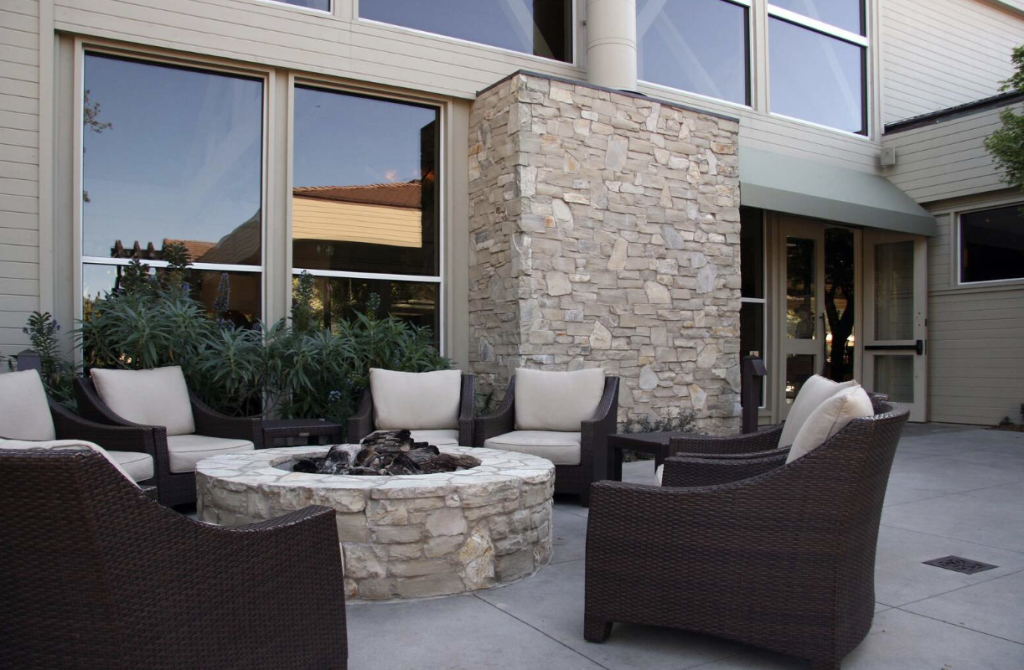 A modern home exterior featuring natural flagstone siding with rustic stone textures and elegant finishes.